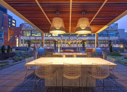 a dining area with a table and chairs under a roof