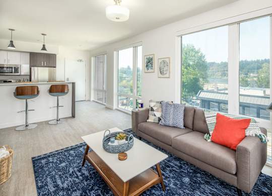 A living room with a grey couch and a coffee table.