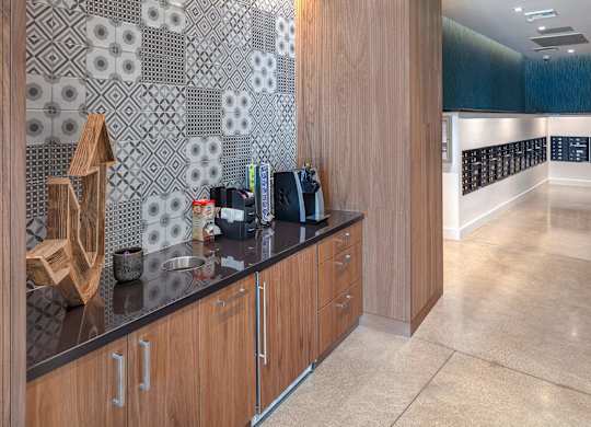 A kitchen with wooden cabinets and a black counter top.