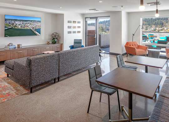 A modern living room with a grey sofa and a wooden table.