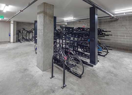 A bike rack with bikes on it in a parking garage.