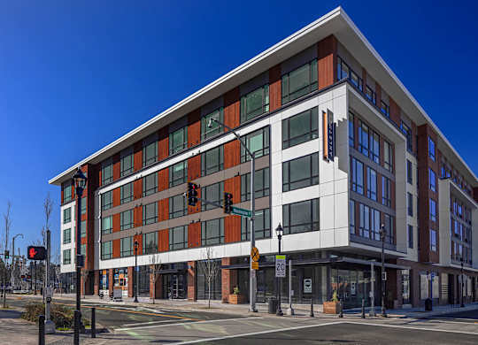 A modern building with a mix of red and white panels.