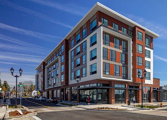 A modern multi-story building with a mix of red and white exterior.