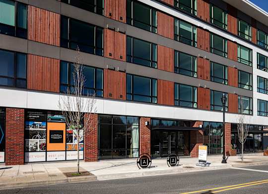 A modern building with a combination of brown and white panels.