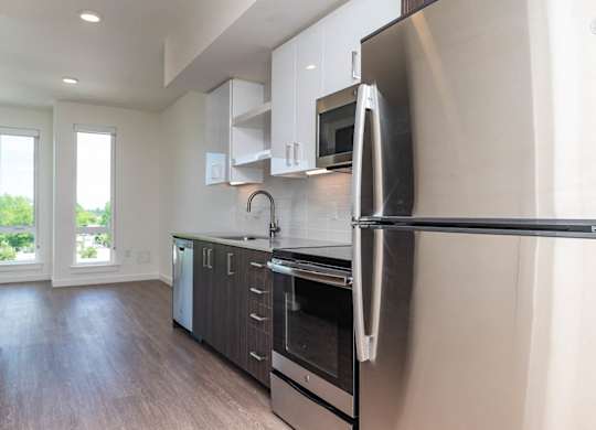 A modern kitchen with a stainless steel refrigerator.