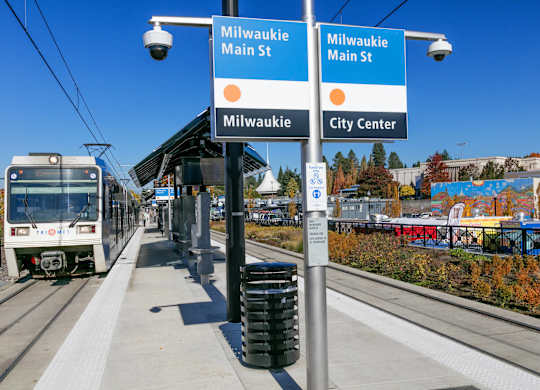 A train is on the tracks at the Milwaukie Main St station.