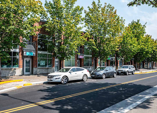 a city street with cars parked in front of buildings