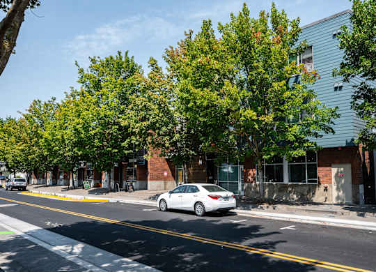 a white car parked in front of a building on a street
