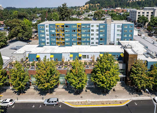 an aerial view of a building with trees in front of it