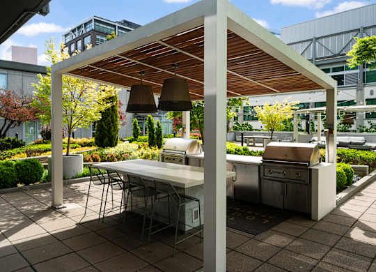 A patio with a table and chairs under a roof.