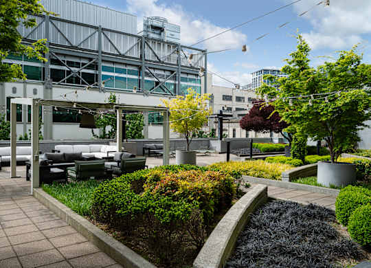 A modern outdoor seating area with a metal structure in the background.