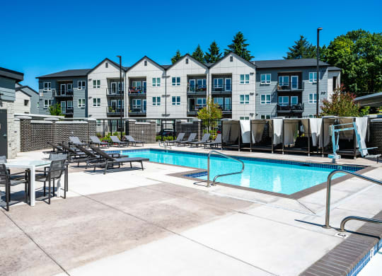 our apartments have a resort style pool with chairs and tables