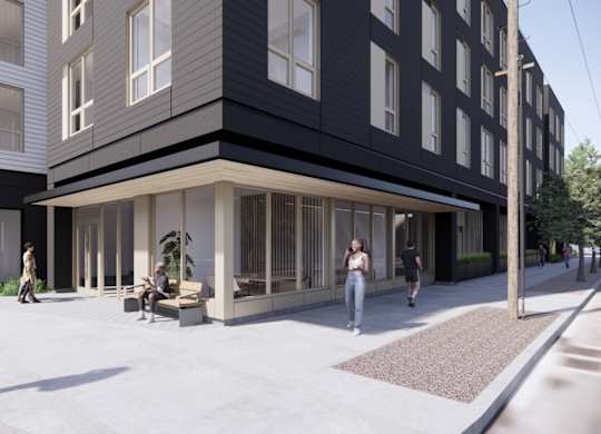 A modern building with people walking around in front.