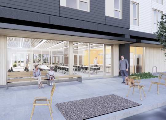 A modern outdoor seating area with people sitting and standing around.