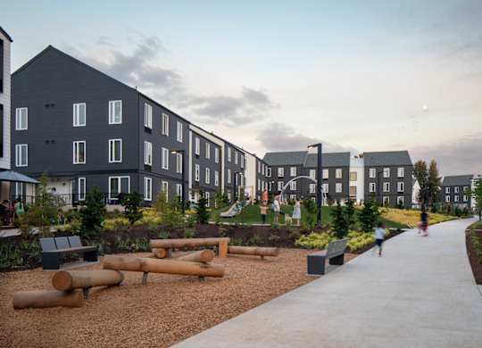 A modern residential area with apartment buildings and a playground.