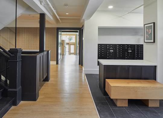 A hallway with a bench and a staircase.
