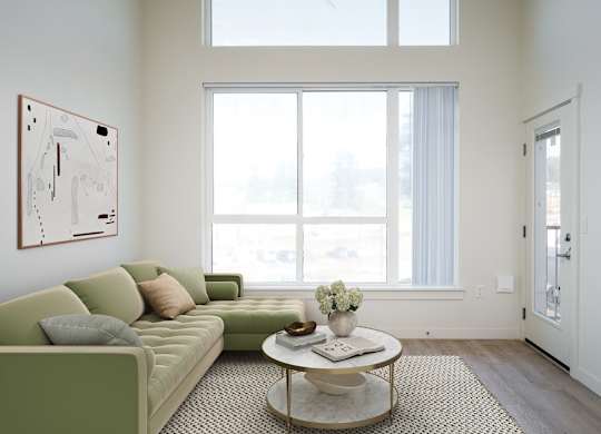 A living room with a green couch and a coffee table.