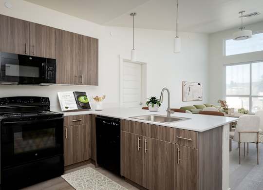 A modern kitchen with a black oven and microwave, wooden cabinets, and a white countertop.