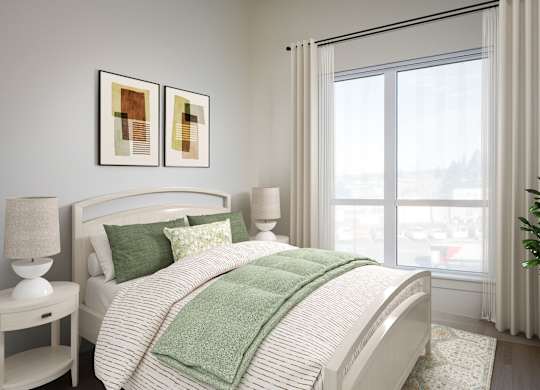 A bedroom with a large bed and two framed pictures on the wall.