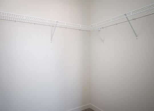 A white wall with a metal rack on it.