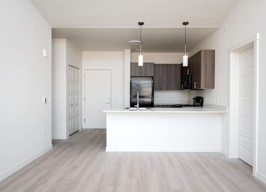 A kitchen with a white counter and cabinets.