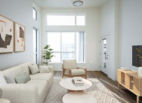 A living room with a couch, chair, and a table.