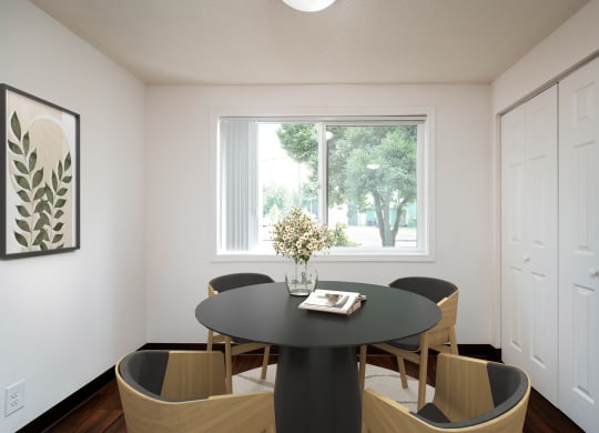 a dining room with a table and chairs and a window