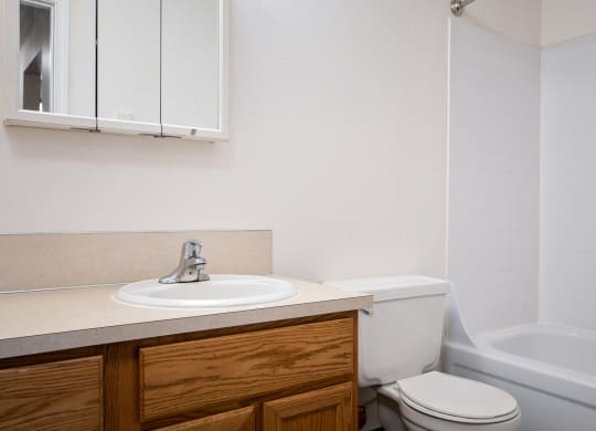 an empty bathroom with a sink toilet and bath tub
