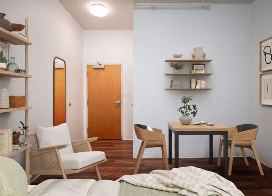 a living room and dining room with a table and chairs