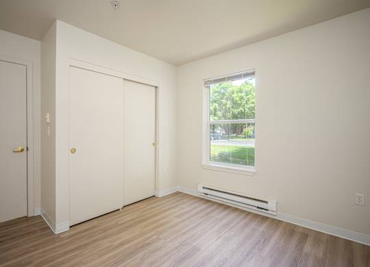 A room with two doors and a window.
