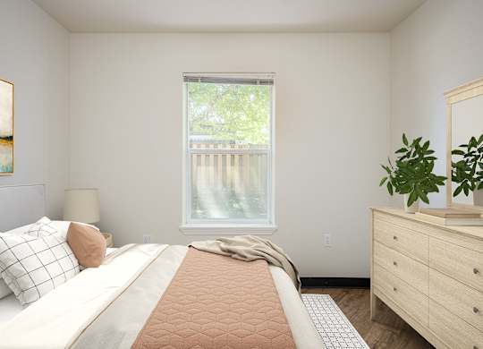 A bedroom with a large bed, a window with a view of a deck, and a wooden dresser.