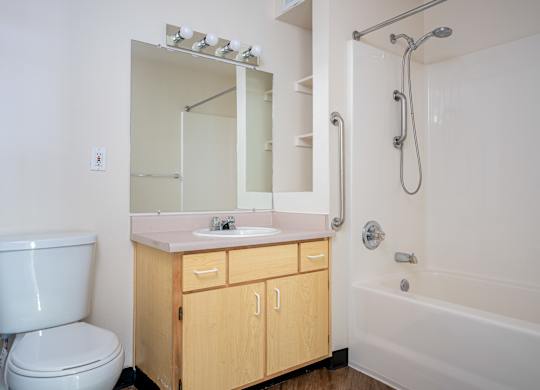 A white bathroom with a sink, toilet, and bathtub.
