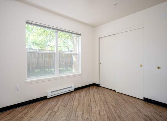 A room with a window and a door.