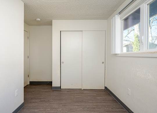 A room with a white door and a window.