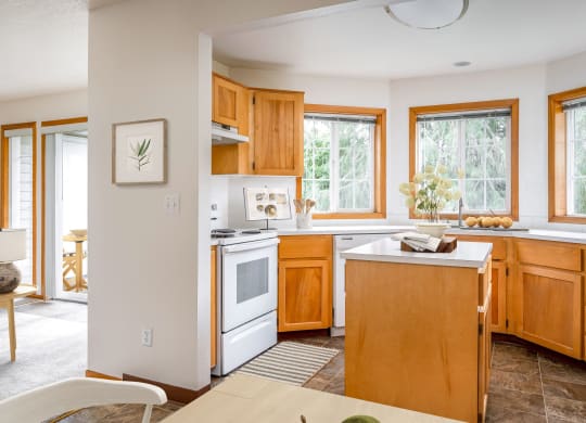 a kitchen with white appliances and wooden cabinets