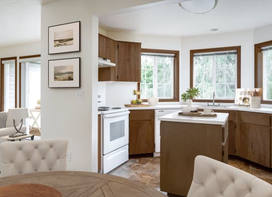 a kitchen with white appliances and wooden cabinets