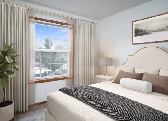 a bedroom with a large bed and a large window
