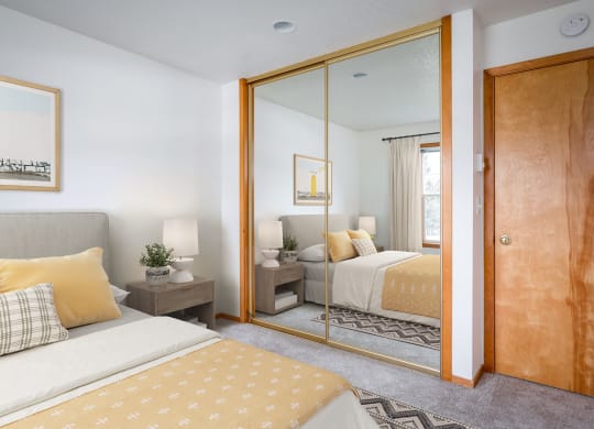 a bedroom with two beds and a large mirror