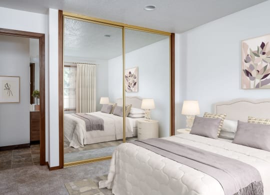 a bedroom with two beds and a large mirror