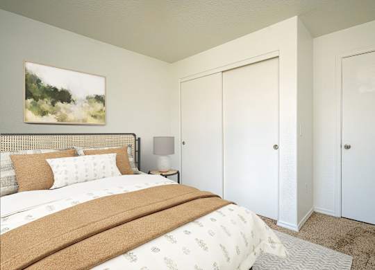 A bedroom with a large bed and a painting on the wall.