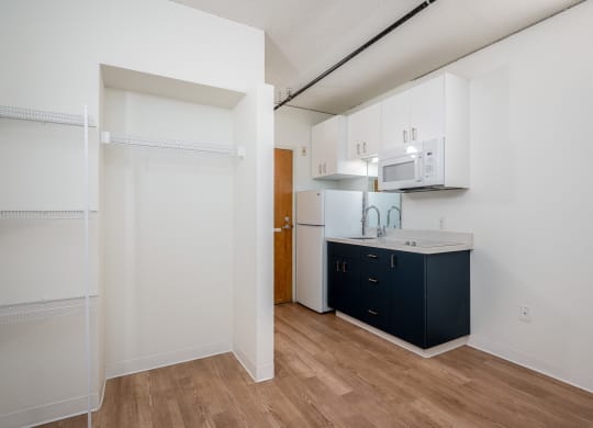 a kitchen with white cabinets and a dark blue island