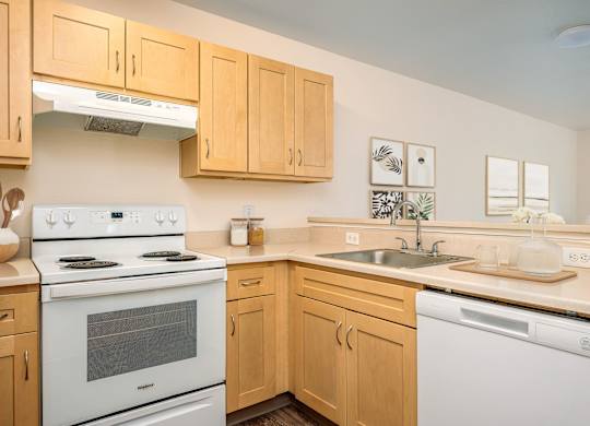 A kitchen with wooden cabinets and white appliances.