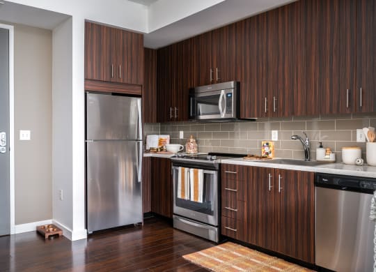 a kitchen with stainless steel appliances and wooden cabinets