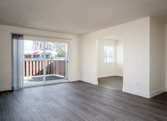 A room with a sliding glass door leading to a balcony.