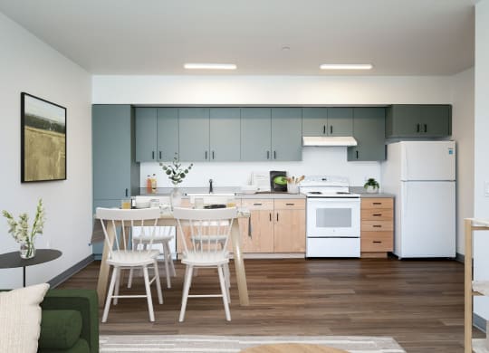 a kitchen with white appliances and a table and chairs