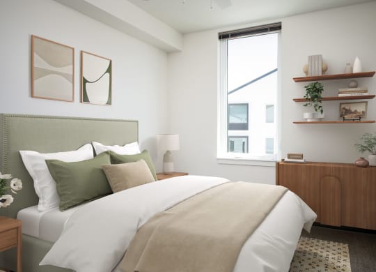 a bedroom with a large bed and a window