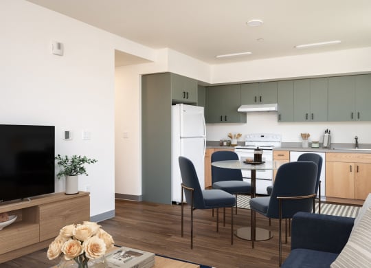 a living room and kitchen with a table and chairs