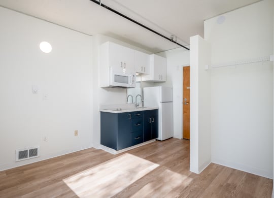 a kitchen with white cabinets and a blue kitchen island