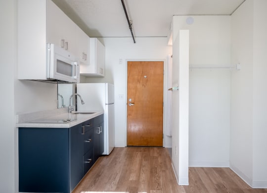 a kitchen with white cabinets and a blue counter top