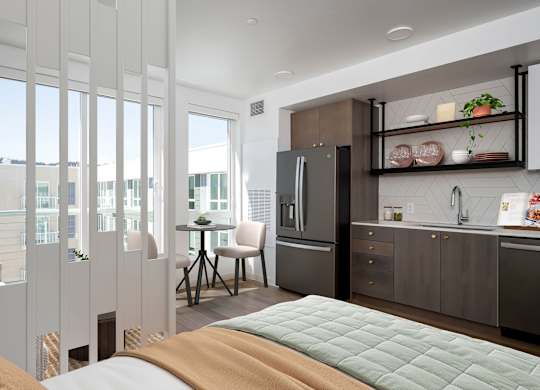 A modern kitchen with a refrigerator, sink, and cabinets.